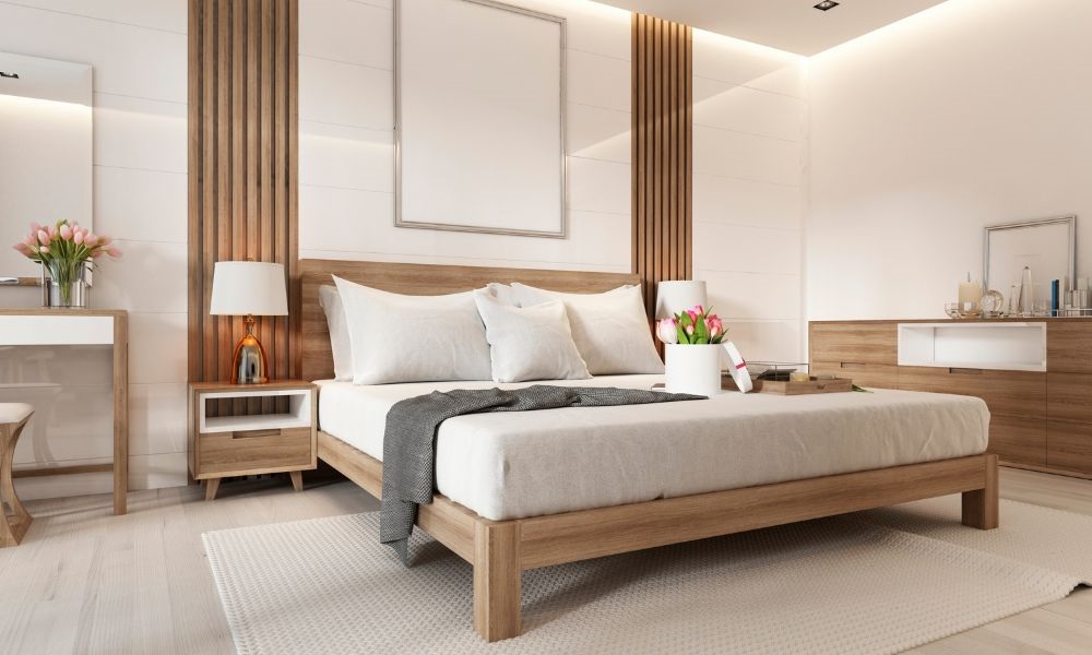 A bed with two light stands left and right in a large room