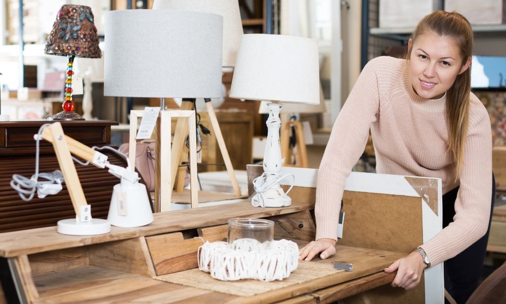 A lady is touching the wooden table with her two hands