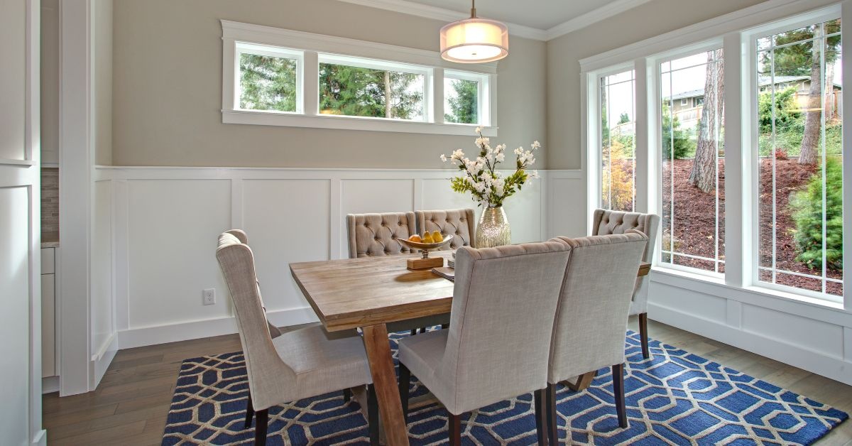 By the window, wooden living Room table with 6 chairs around