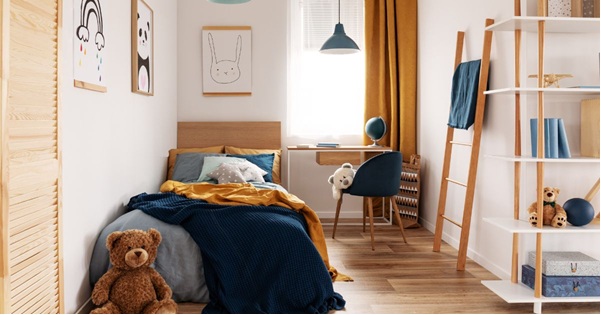 Two young ladies talking one holding a book another with box in a collge dorm
