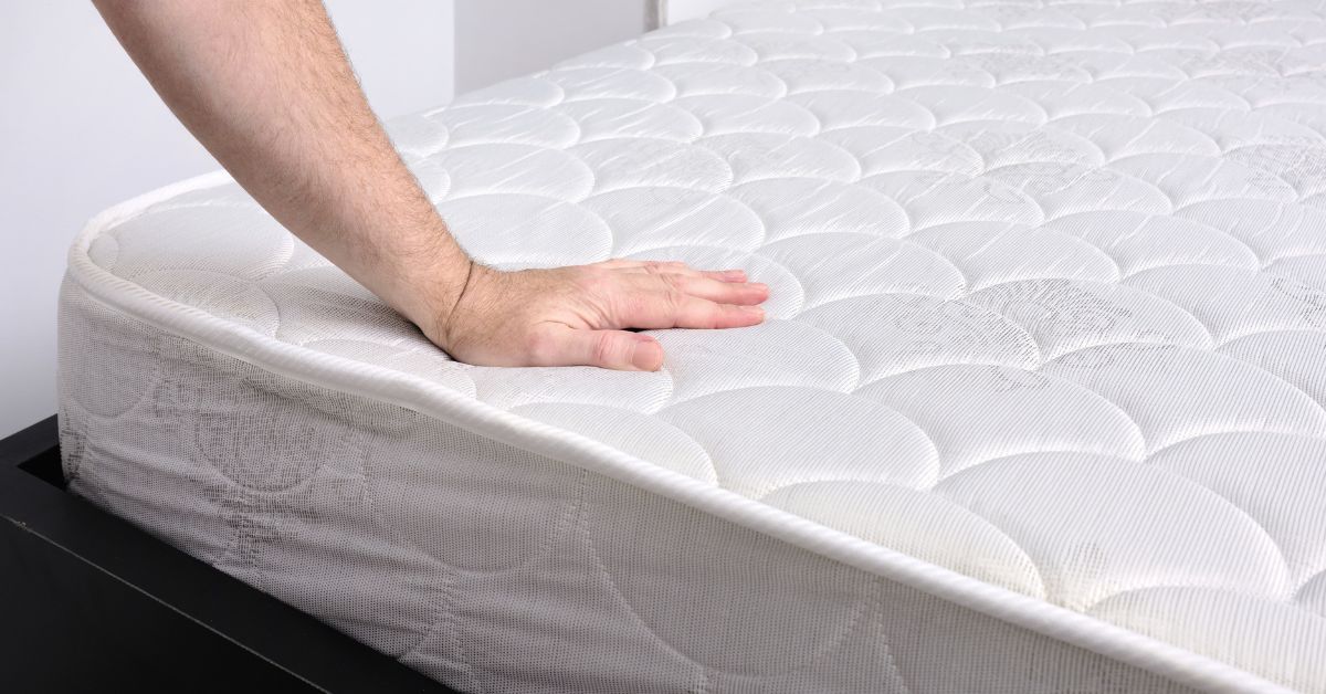 Checking Cushion with a hand on a bed